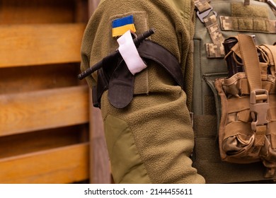 A military man holds a medical tourniquet in his hands to stop blood in first aid and prevent bleeding. Combat tactical equipment. Combat use Turnstile.