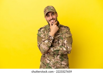 Military Man Isolated On Yellow Background Smiling