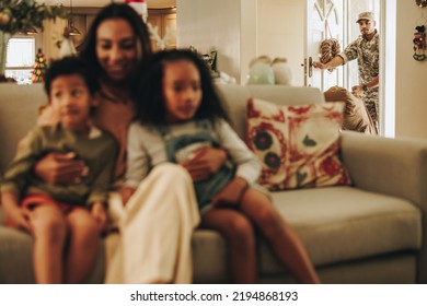 Military Man Making A Surprise Homecoming. Soldier Returning To His Wife And Children After Serving In The Army. Serviceman Arriving Home From Deployment.