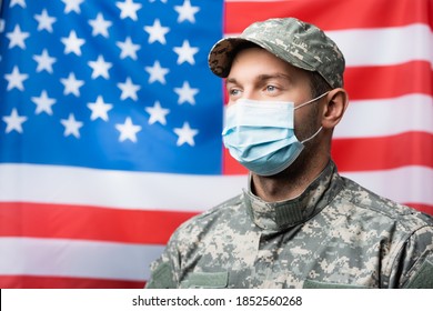 military man in medical mask near american flag on blurred background