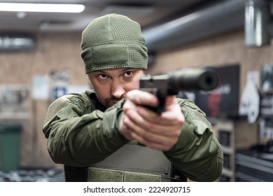 A Military Man Shoots At A Shooting Range From A Pistol With A Silencer.  Baltic States, September 2022.