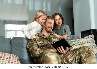 Military man spending time at home with his loving wife and daughter. Family reunion or returning home concept  - Powered by Shutterstock