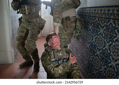 Military men helping wounded friend. Caucasian men with carrying injured teammate. Military, army, danger, fighting, airsoft concept