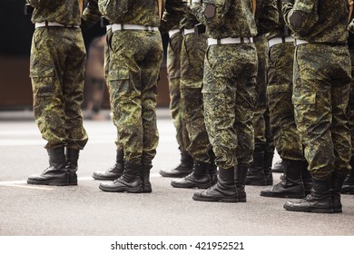 military men stand at attention