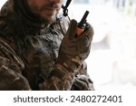 Military mission. Soldier in uniform with radio transmitter inside abandoned building