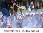 Military officer planting U.S, flags on Boston Common during Memorial Day ceremony in Boston, 