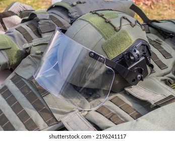 Military Outfit. Clothing For Army Soldier. Helmet And Body Armor For Soldier. Helmet With Protective Glass For Eyes. Concept Selling Military Uniforms. Uniform For Soldier Lies On Ground.