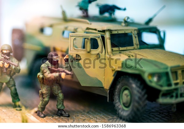 Military\
patrol car. Army war concept. Armored vehicle with soldiers ready\
to attack. Artwork decoration. Selective\
focus.