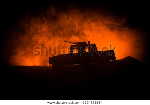 Military patrol car on dark toned foggy\
background. Army war concept. Silhouette of armored vehicle with\
gun in action. Decorated. Selective\
focus