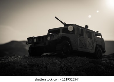 Military Patrol Car On Sunset Background. Army War Concept. Silhouette Of Armored Vehicle With Gun In Action. Decorated. Selective Focus