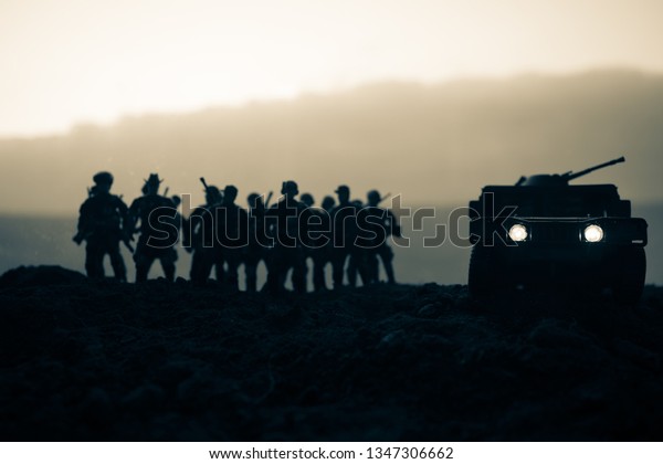 Military patrol car on sunset background.\
Army war concept. Silhouette of armored vehicle with soldiers ready\
to attack. Artwork decoration. Selective\
focus