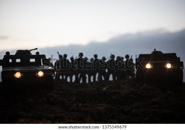 Military patrol car on sunset background.\
Army war concept. Silhouette of armored vehicle with soldiers ready\
to attack. Artwork decoration. Selective\
focus