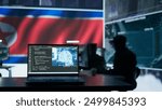 Military personnel working next to AI brain neural network in a command post with a North Korea flag on big screen. IT engineer employing deep learning to spread misinformation for scams. Camera B.