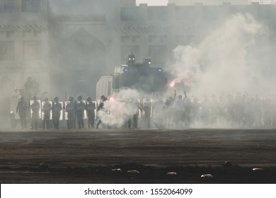 Military police riot response to a protest with tear gas, smoke, fire, explosions. Political expression, riot, protest, demostration and military concept.