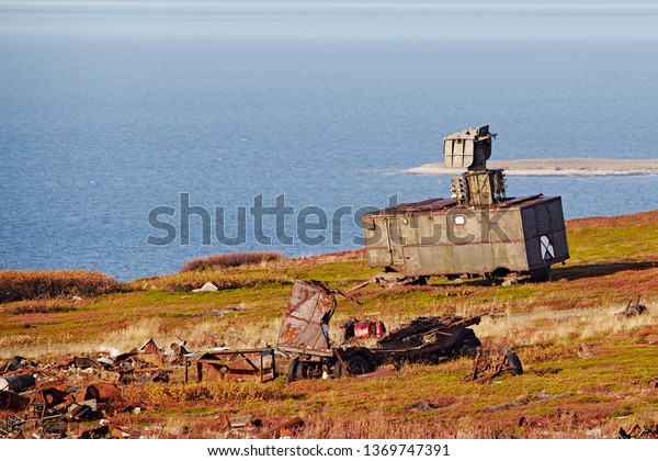 Military radar
and locator on the car. Abandoned equipment on the background of
the autumn landscape, sea and blue
sky