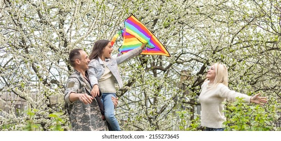 Military Reunion Between Father And Daughter. Military Dad Embracing His Daughter On His Homecoming. Army Soldier