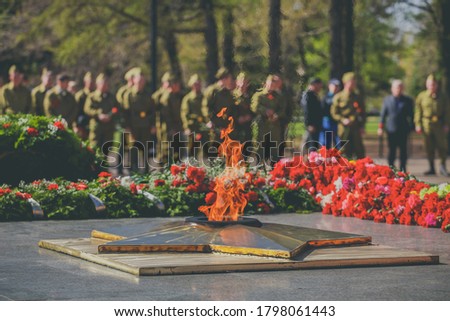 The military salutes monument to soldiers who died in World War. Victory Day Parade. Eternal Flame monument with star and flowers at Grave of Unknown Soldier - symbol of victory in Second World War