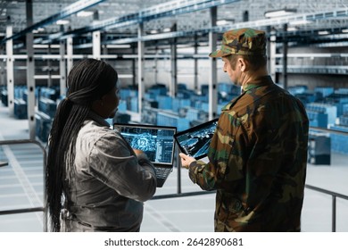 Military server hub personnel analyzing AI enhanced surveillance data together. Commander in data center and expert discussing AI generated target coordinates displayed on digital map interface