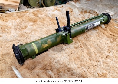 Military, Shooting RPG Anti Tank Grenade Launcher Lying On The Sand. War Trophy. Military Supplies Of Heavy Weapons