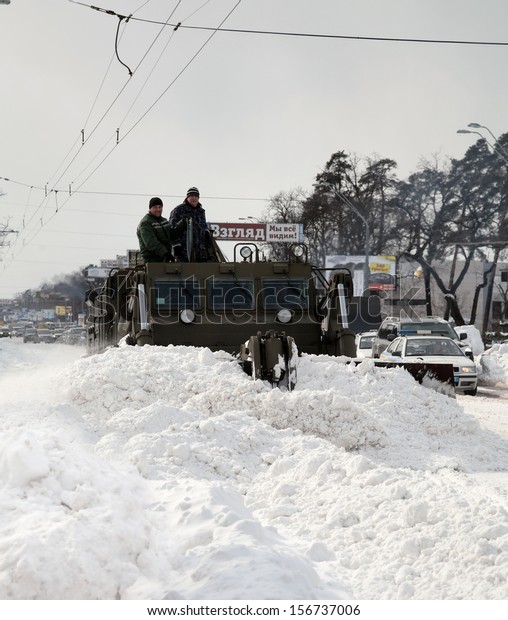 Military Snow-removal machine. Kiev,\
Ukraine - March 24, 2013: Pobedy ave. The picture is taken on\
Pobedy avenue in Kiev on a spring day after huge snow\
blizzard.