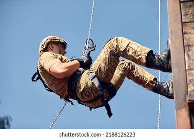 Military soldier climbing net during obstacle course in boot camp - Powered by Shutterstock