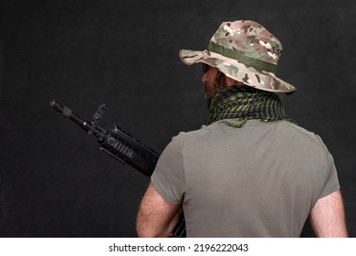 A Military Soldier With A Rifle In His Hands On A Black Background . Concept: Military Action, Soldier Of Fortune, Army Offensive.