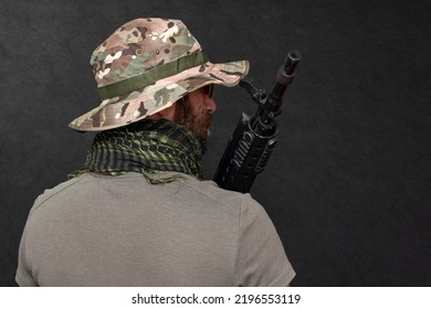 A Military Soldier With A Rifle In His Hands On A Black Background . Concept: Military Action, Soldier Of Fortune, Army Offensive.