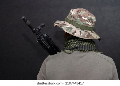 A Military Soldier With A Rifle In His Hands On A Black Background . Concept: Military Action, Soldier Of Fortune, Army Offensive.