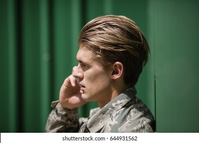 Military Soldier Talking On Mobile Phone In Boot Camp