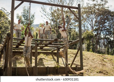 Military Soldiers Training Rope Climbing At Boot Camp