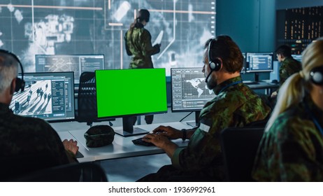 Military Surveillance Officer Working on Computer with Green Screen in Central Office for Cyber Operations, Control and Monitoring for Managing National Security, Technology and Army Communications.