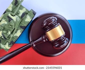 Military Tank Russian Aggression Stand On Flag Of Russia And Judicial Gavel. Detailing Concept Of Denazification And Reparations Of Russia