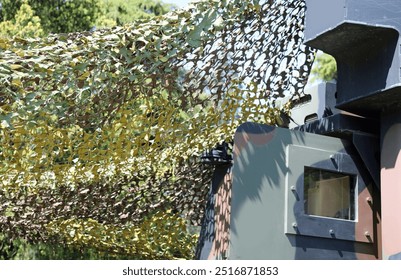 military tent with camouflage fabric to camouflage among the vegetation during the exercise in a training camp for soldiers - Powered by Shutterstock