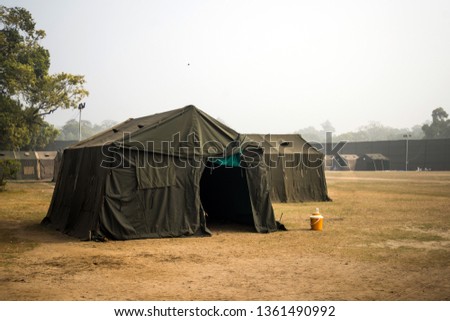 Military tent in the field. big tent city. field camp in nature. military base with temporary barracks. military exercises of the soldiers. large military tent. Army camp. reconstruction warfare