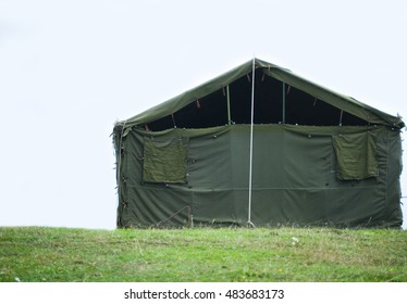 A Military Tent In Green Field.