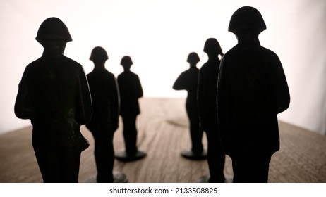 Military theme. Army, military, metal figures of soldiers 4k. Toy soldiers on a black background.
