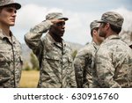 Military trainer giving training to military soldier at boot camp