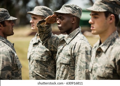 Military trainer giving training to military soldier at boot camp - Powered by Shutterstock