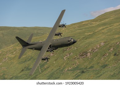 Military transport aeroplanes flying low level in the UK low fly system through the Mach Loop, Machynlleth, Wales UK. 