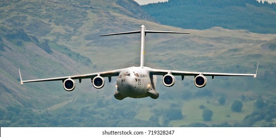 Military Transport Aircraft Flying Low Level Stock Photo 719328247 military-transport-aircraft-flying-low-level-stock-photo-719328247
