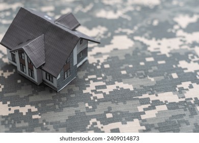 a military uniform and a toy house - Powered by Shutterstock