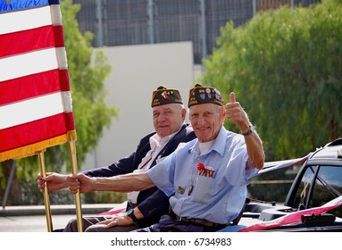 Military Veterans Holding Flags In Parade