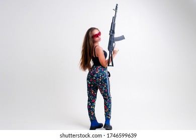 Military Woman With A Machine Gun In Her Hands