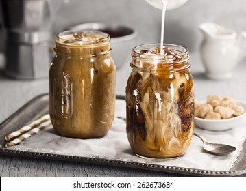 Milk Being Poured Into Iced Coffee