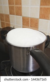 Milk Boiling Over A Pan