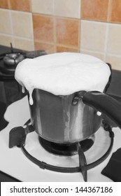 Milk Boiling Over A Pan