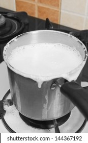 Milk Boiling Over A Pan