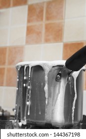 Milk Boiling Over A Pan