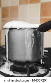 Milk Boiling Over A Pan