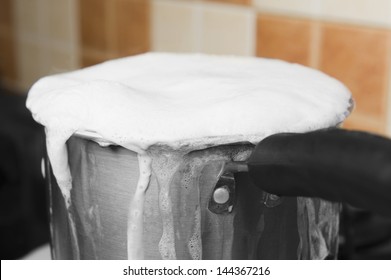 Milk Boiling Over A Pan